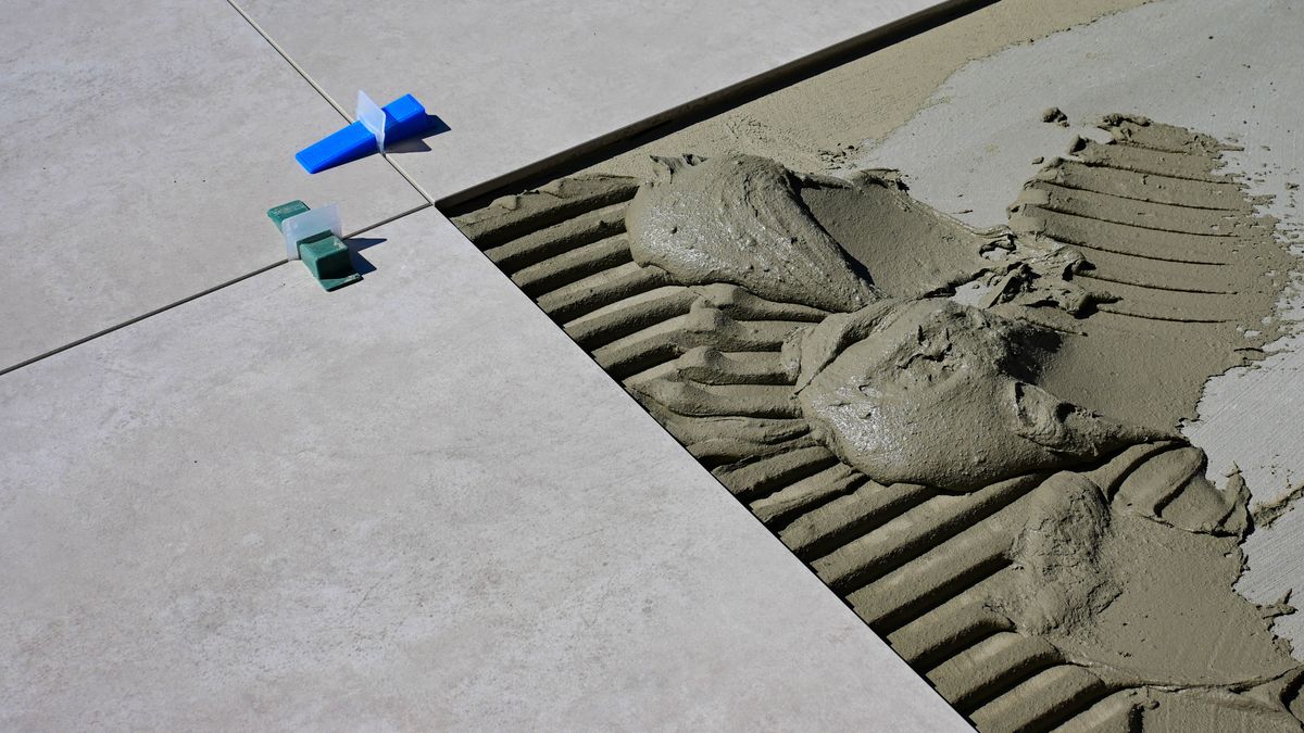 Peel-and-Stick Tile Adhesive Creeps Downward on Vertical Surfaces